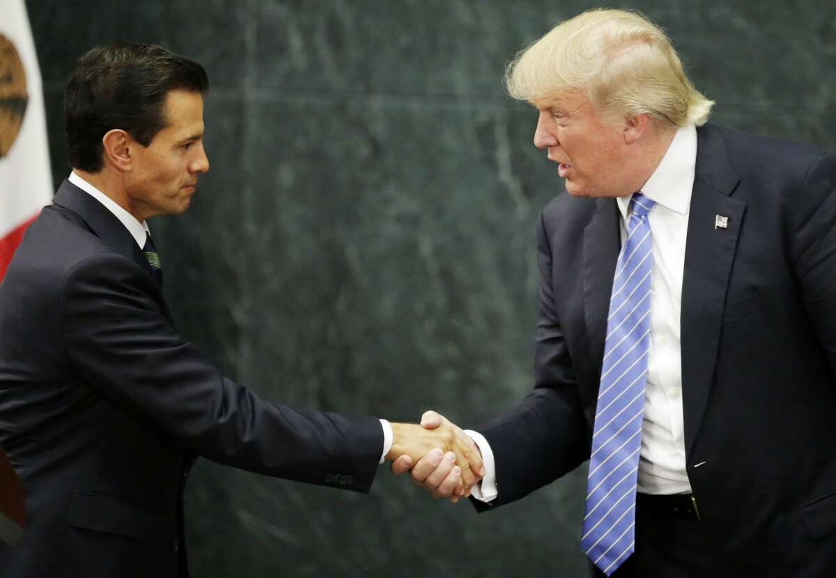 Mexican President Enrique Pena Nieto (L) and US presidential candidate Donald Trump shake hands after a meeting in Mexico City on August 31, 2016.