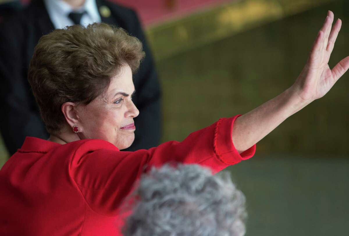 Brazil's suspended President Dilma Rousseff waves to supporters before speaking from the official residence of the president, Alvorada Palace in Brasilia, Brazil, Wednesday, Aug. 31, 2016. In her first remarks after being ousted as Brazil's president, Rousseff is vowing to form a strong opposition front against the new government, saying, "They think that they beat us, but they are wrong." (AP Photo/Leo Correa)