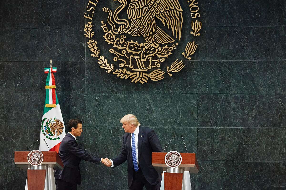 Mexican President Enrique Pena Nieto and Donald Trump, the Republican presidential nominee, shake hands during a joint news conference, after the two met at the Los Pinos residence in Mexico City, Aug. 31, 2016. Trump said he focused on shared economic interests and security interests in their meeting. He also said he did discuss his intention to build a wall on the U.S.-Mexico border, but that the two did not discuss who would pay for it. (Rodrigo Cruz/The New York Times)
