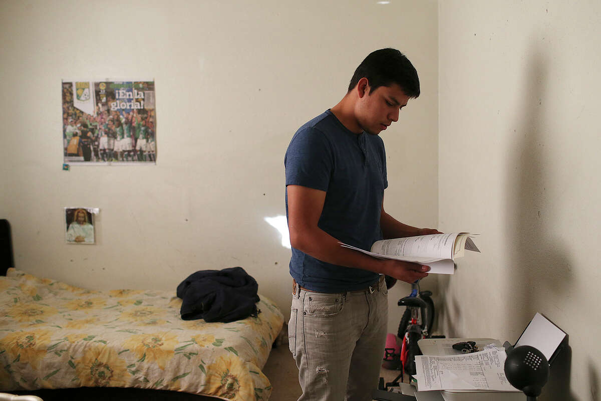 Luis Osvaldo Rocha, 20, looks over his paperwork while in the family's apartment in the city's south side, Tuesday, February 17, 2015. Rocha, a student at Palo Alto College, was hoping to file the paper work today but didn't due to a temporary court order issued by Brownsville Federal Judge Andrew Hanen halting part of President Barack Obama's executive action on immigration reform. The lawsuit was filed by the state of Texas. Rocha, who is from Guanajuato, said, "It's a sad thing. Maybe they, (Govenor Greg Abbott), haven't met people like us. We're hardworking people."