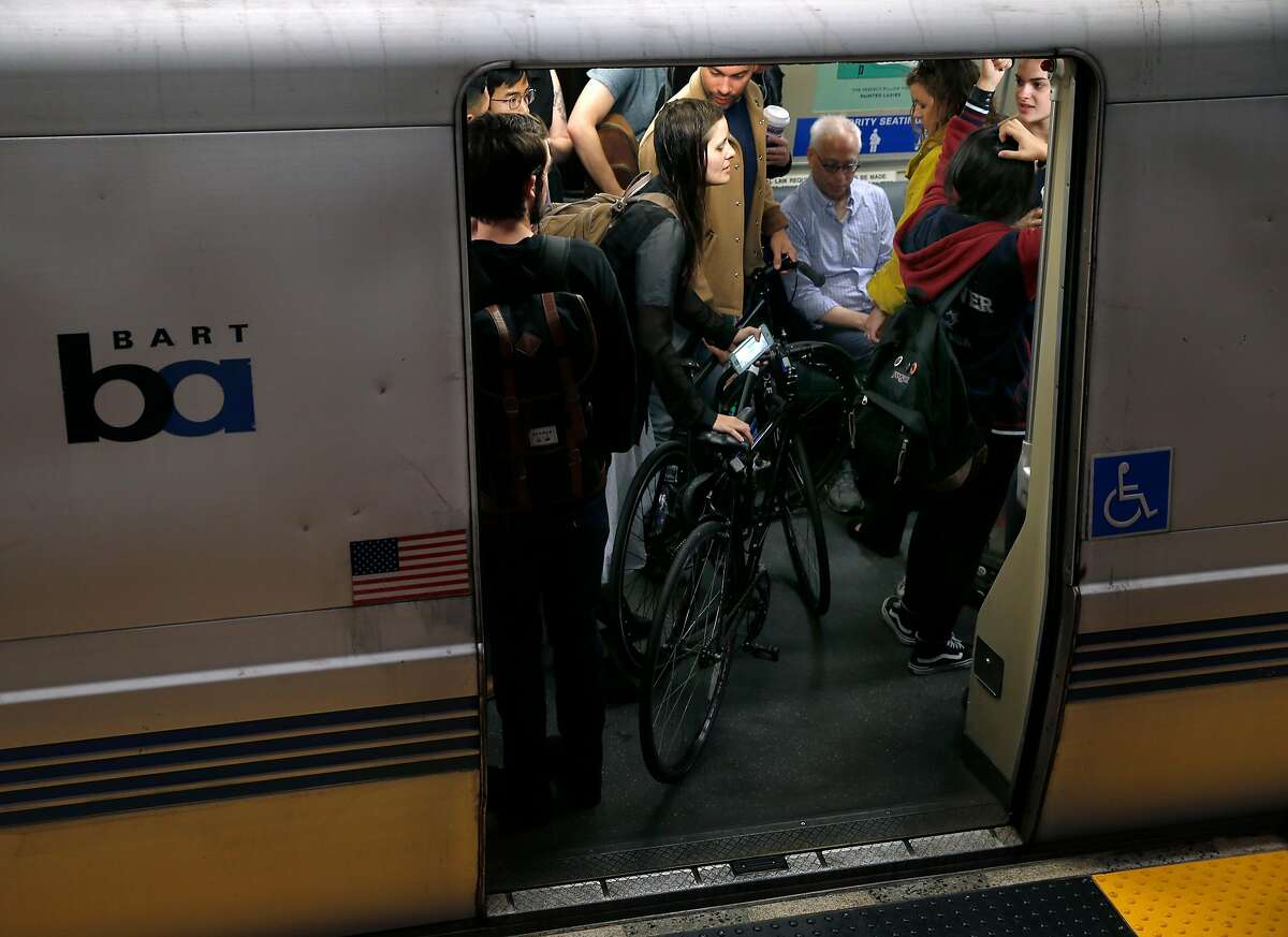 Passengers stand inside a train headed to San Francisco at the 19th Street BART station in Oakland, Calif. on Aug. 30, 2016.