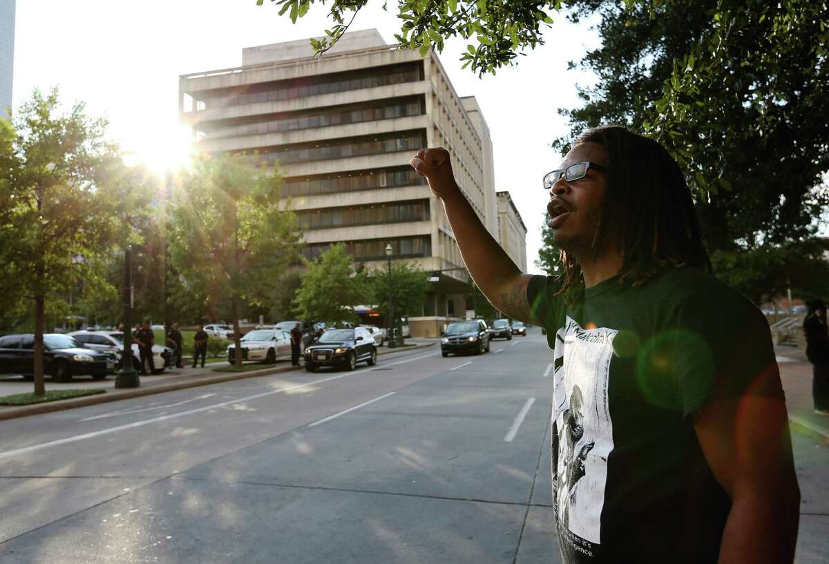Gregory Chatman shouts across the street to the police at the protest.
