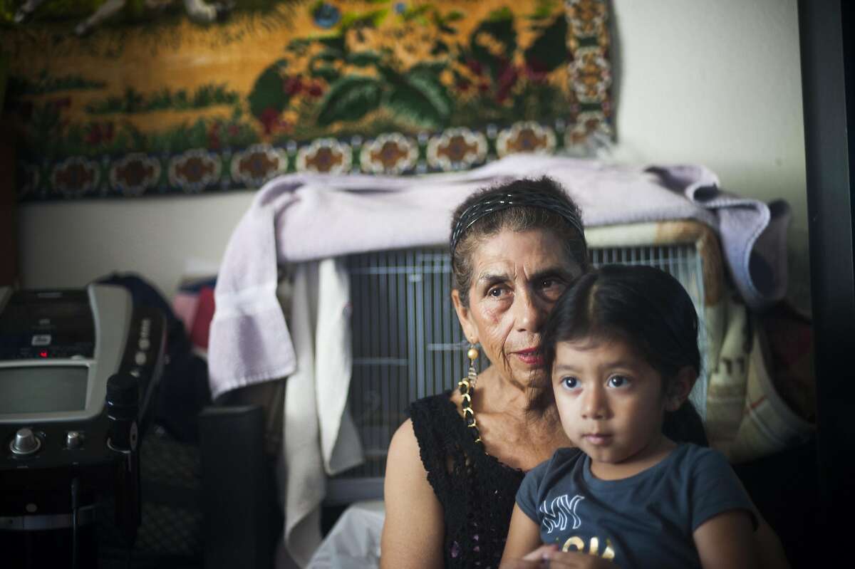 Farmworker Obdulia Salinas with her granddaughter Eneya, photographed at her home in Santa Rosa, CA on August 31, 2016. Recent state legislation is headed to the governor's office that would provide farmworkers overtime pay after eight hours of work.