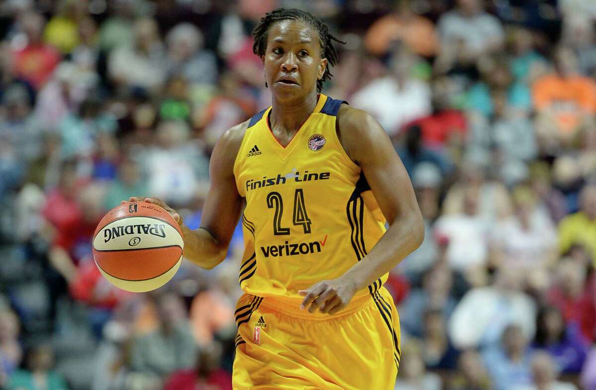 Indiana Fever's Tamika Catchings, right, makes a pass in front of