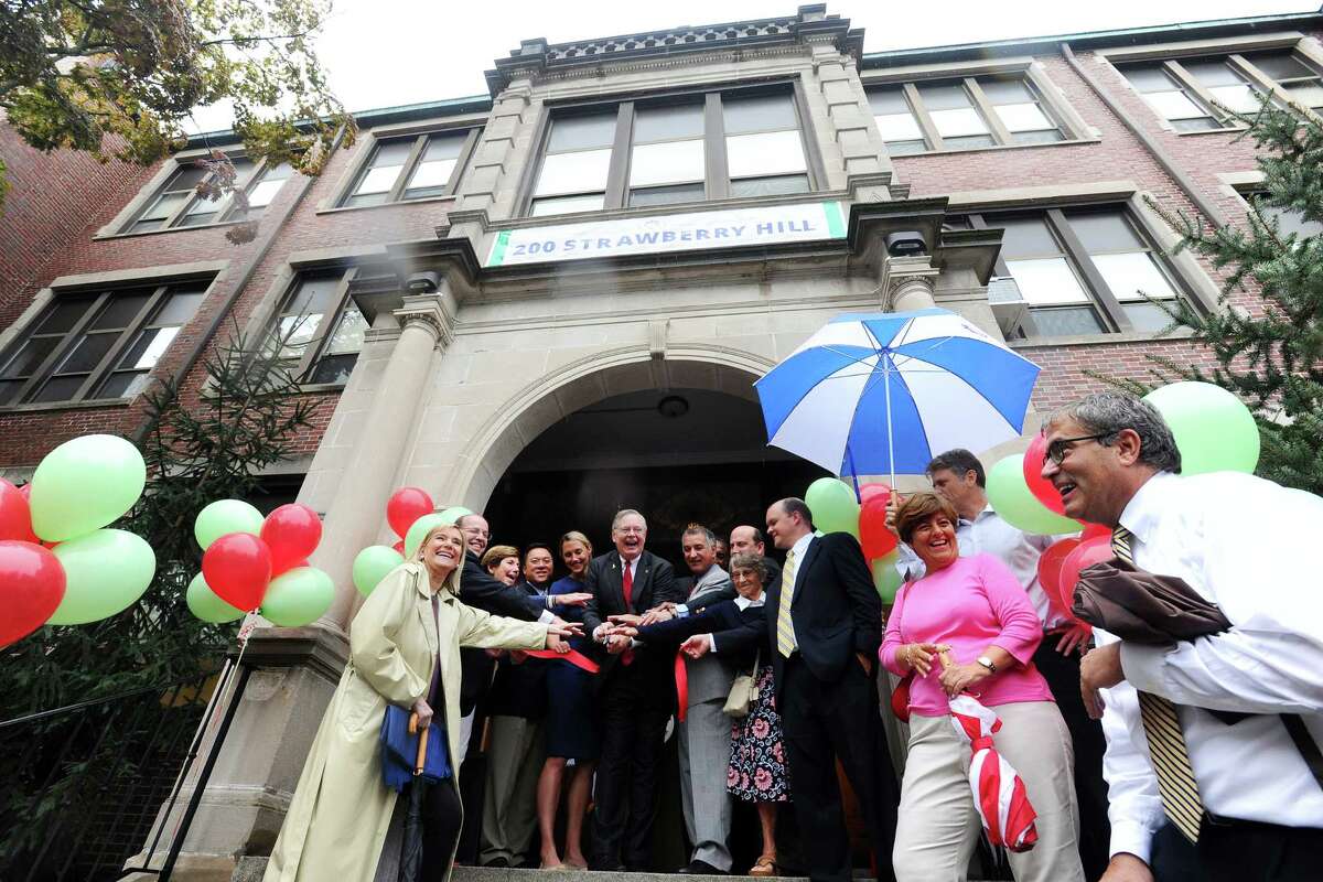 Local officials, led by Stamford Mayor David Martin (center) officially cut the ribbon for the New School, on Strawberry Hill Ave. in Stamford, Conn., on Thursday, September 1, 2016.