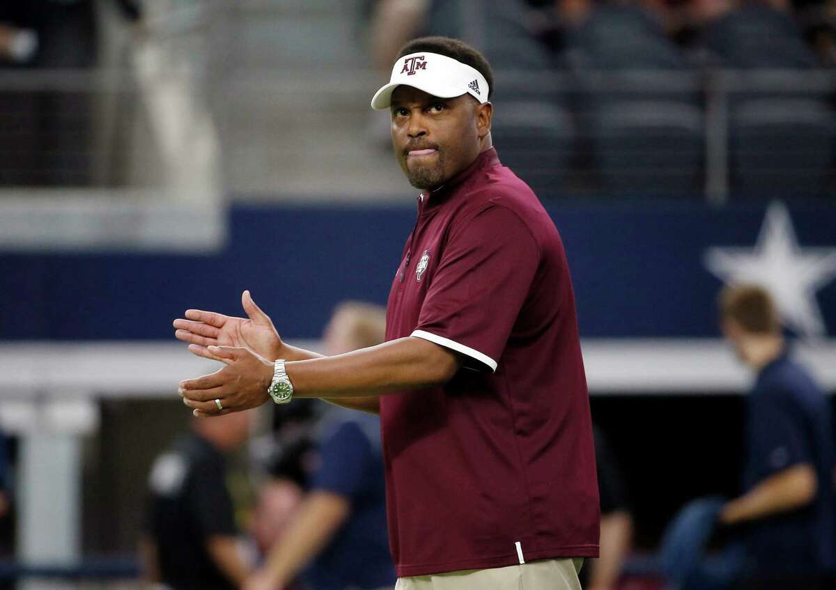 FILE - In this Saturday, Sept. 26, 2015 file photo, Texas A&M coach Kevin Sumlin applauds his team as players warm up for an NCAA college football game against Arkansas in Arlington, Texas. Steve Shaw has a busy week at the Southeastern Conference's annual meetings. Shaw, the league's coordinator of officials, is getting SEC coaches and administrators prepared for centralized replay, an experimental effort between the SEC office's command center and the replay official at games.(AP Photo/Tony Gutierrez, File)
