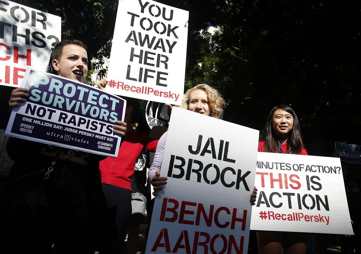 Protesters hold signs at a rally to call for Judge Aaron Persky's removal from the bench across the street from the Santa Clara County Main Jail in San Jose, Calif. on Sept. 2, 2016. Brock Turner was released from jail earlier in the morning after serving half of a six month sentence issued by Persky after Turner was found guilty of raping an unconscious female student.