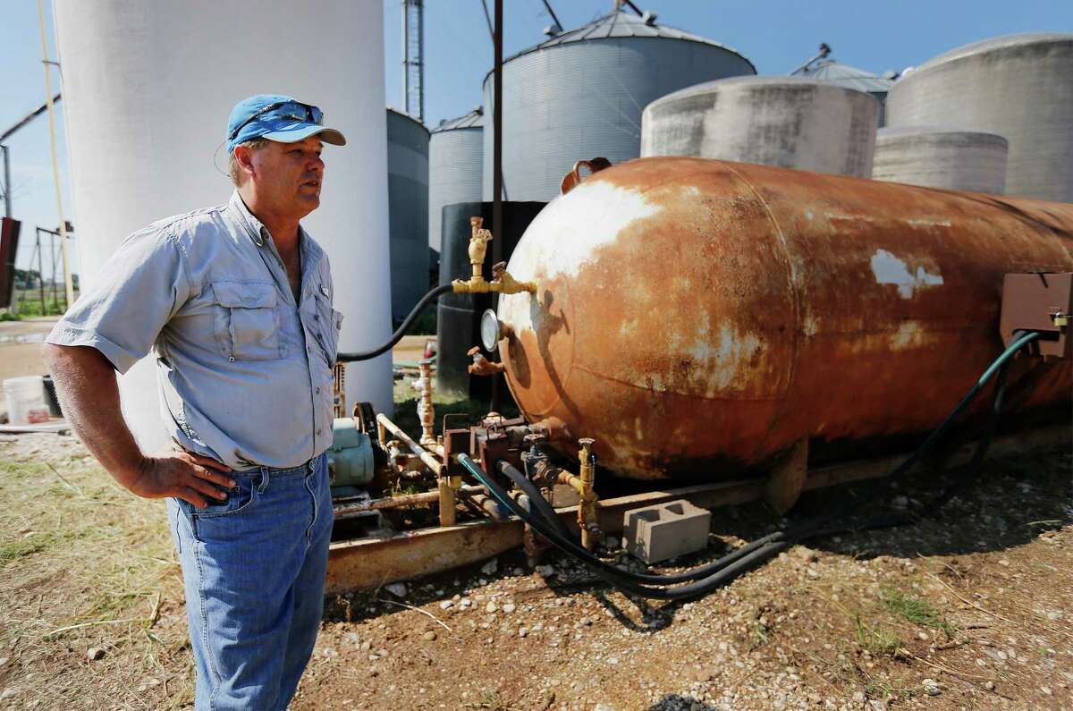 Anhydrous ammonia is used as fertilizer in farming for decades. Like many farmers Charles Krakau (pictured), uses anhydrous ammonia on his farm land in Barbarosa, Texas in Guadalupe County. Krakau also sells the fertilizer to nearby farmers as well. In the wake of the West, Texas Fertilizer Plant explosion in 2013, new federal regulations overseeing agricultural fertilizers like anhydrous ammonia and ammonium nitrate will come into effect on October 1 and fines for non-compliance with the new rules can be steep. Krakau, standing by his 20-ton tank of anhydrous ammonia, said he has already received such a fine when he sold anhydrous ammonia to another farmer but the tank in which the chemical solution was transported was not properly tagged and thus Krakau received a fine. The cost for compliance may put retailers of the fertilizer out of business particularly smaller operations. Also, the trickle-down costs for farmers to reach compliance or use alternative fertilizers will hurt their bottom lines of which margins are already small. (Kin Man Hui/San Antonio Express-News)