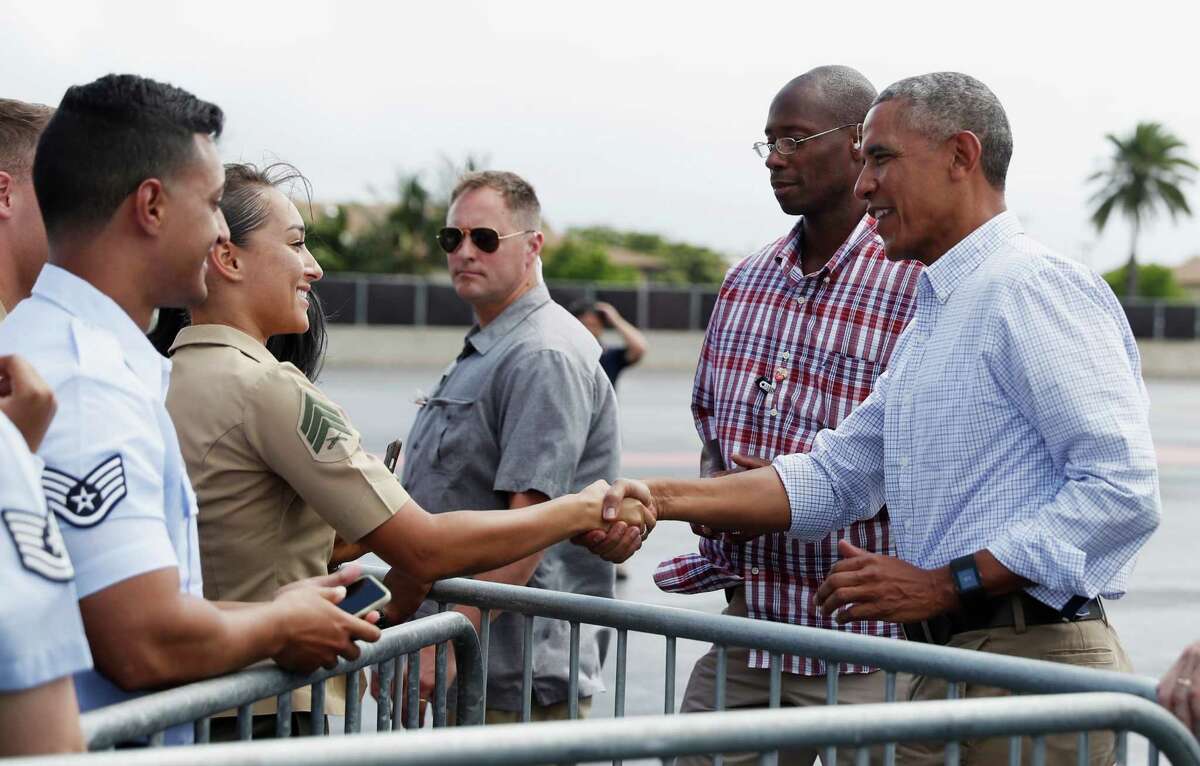 President Barack Obama greets members of the military on the tarmac Friday before boarding Air Force One at Joint Base Pearl Harbor-Hickam, adjacent to Honolulu﻿. ﻿