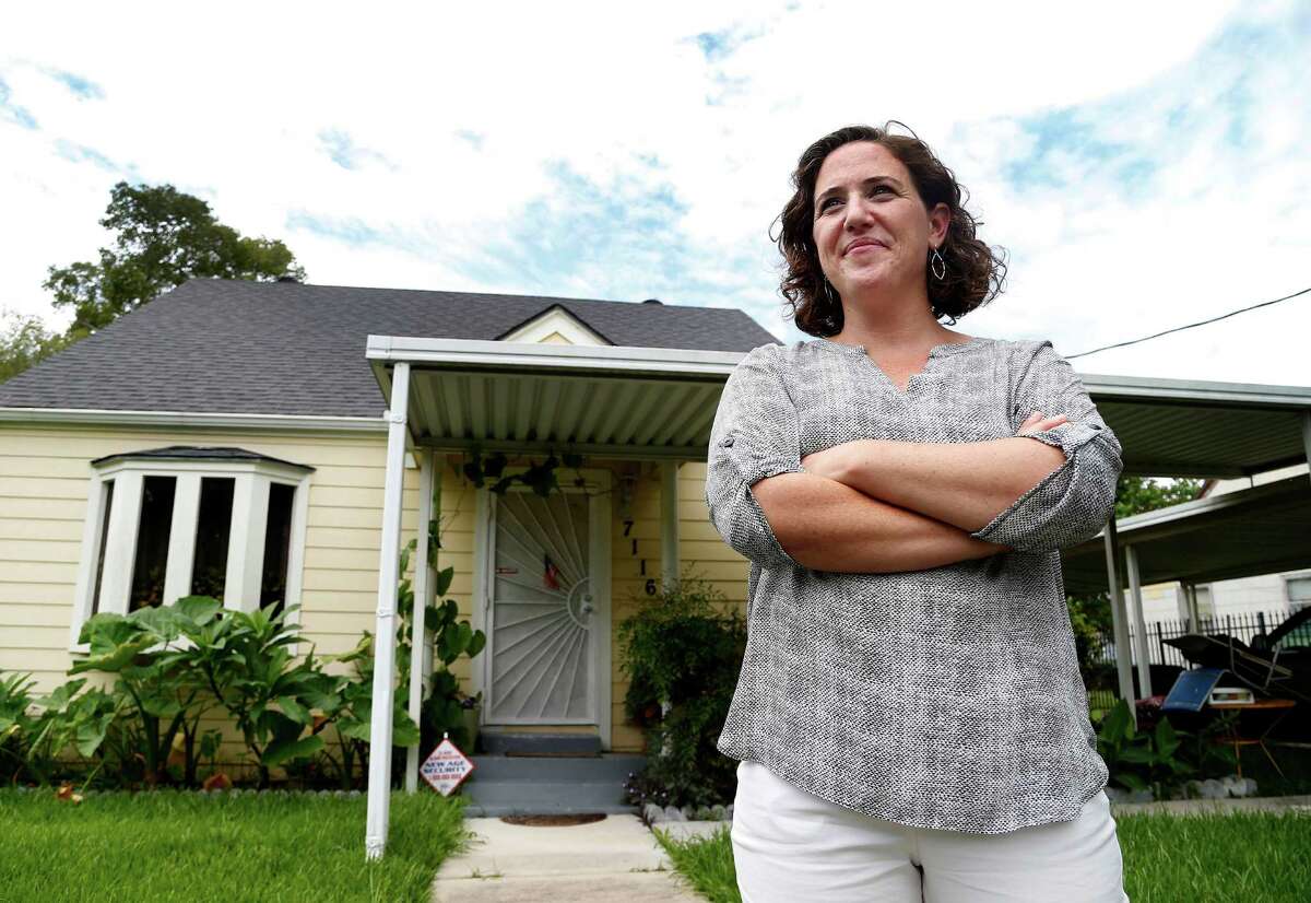 Ginny Goldman, founder of the Texas Organizing Project, stands in front of a Houston home repaired after a long battle over Hurricane Ike recovery funds.  