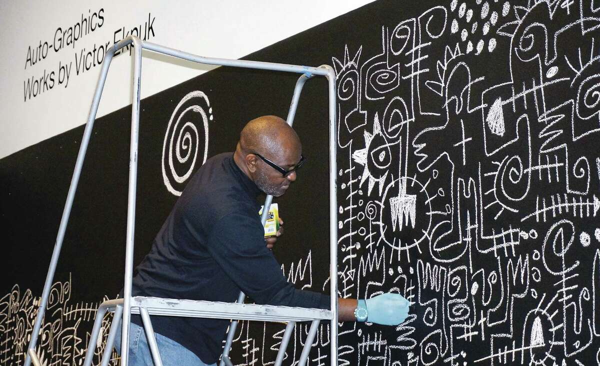 Artist Victor Ekpuk will create a new wall drawing at the Frances Young Tang Teaching Museum and Art Gallery at Skidmore College as part of the exhibition "Sixfold Symmetry: Pattern in Art and Science." Here he creates a wall drawing in April 2015 at the Hood Museum of Art at Dartmouth College. (Photograph by Alison Palizzolo.(