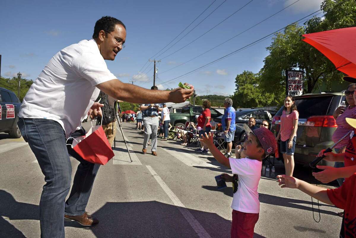 In this file photo, U.S. Rep. Will Hurd, who is running for re-election in the Texas' 23rd Congressional District race, greets bystanders in Helotes during a parade honoring the members of the 2016 Little League World Series softball championship team.