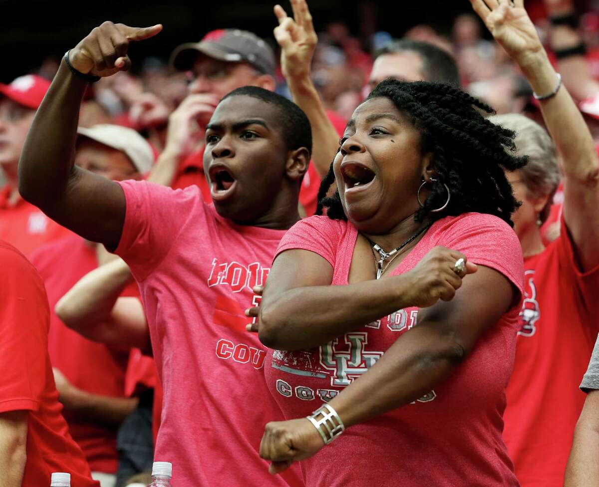 University of Houston football fans Natalie Dickson and her son Nassen Sharrieff react to a play during the second half of the Advocare Texas Kickoff Game against University of Oklahoma at NRG Stadium Saturday, Sept. 3, 2016, in Houston . The Cougars won the game 33-23.