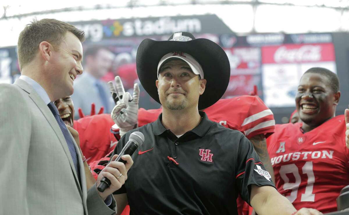 Houston Cougars head coach Tom Herman smiles after his team put the trophy hat on him after the beat Oklahoma Sooners 33-23 in the Advocare Texas Kickoff on Saturday, Sept. 3, 2016, at NRG Stadium in Houston.