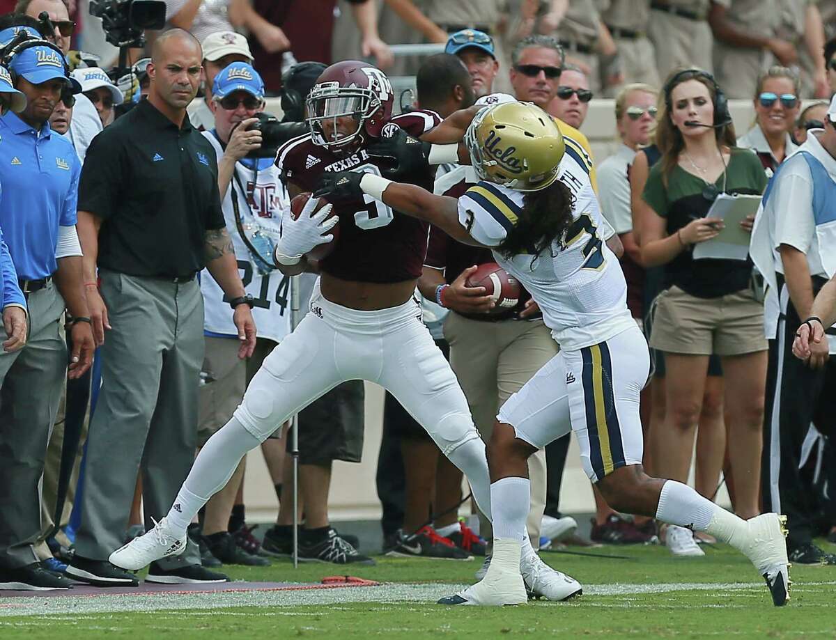 Texas A’s Christian Kirk is forced out of bounds by UCLA’s Randall Goforth in the first quarter at Kyle Field on Sept. 3, 2016 in College Station.