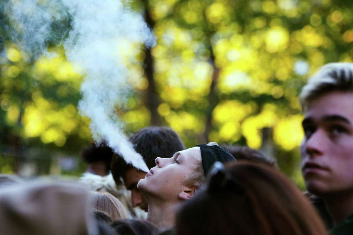 A member of the crowd blows out vape smoke on day two of Bumbershoot, Saturday, Sept. 3, 2016.