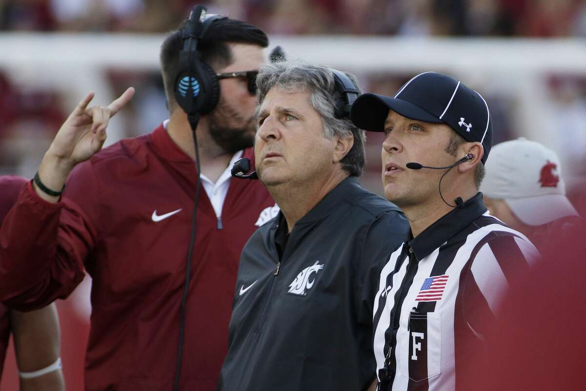 Washington State head coach Mike Leach, center, watches a replay during the first half of an NCAA college football game against the Eastern Washington in Pullman, Wash., Saturday, Sept. 3, 2016. (AP Photo/Young Kwak)