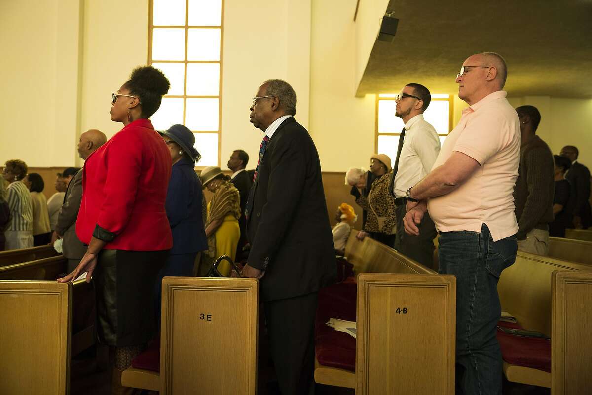 Members of the congregation stand during Sunday service at Third Baptist Church where San Francisco quarterback Colin Kaepernick was scheduled to speak in San Francisco, Calif. on Sunday, Sept. 4, 2016. Kaepernick was unable to attend due to "rigors of training," according to Rev. Amos Brown.