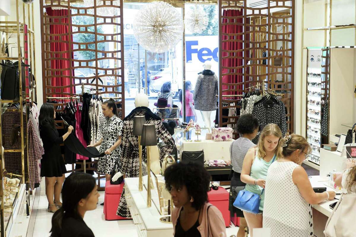 Customers and employees are shown at a Kate Spade store in New York. Retailers were hit hard last month. That industry showed the weakest two months for hiring since the end of 2009, battered at least in part by the broader trend of Americans flocking to online merchants rather than brick-and-mortar stores.