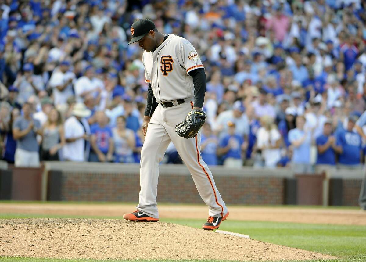 San Francisco Giants relief pitcher Santiago Casilla reacts after giving up the tying run to the Chicago Cubs during the ninth inning of a baseball game, Sunday, Sept. 4, 2016, in Chicago. (AP Photo/David Banks)
