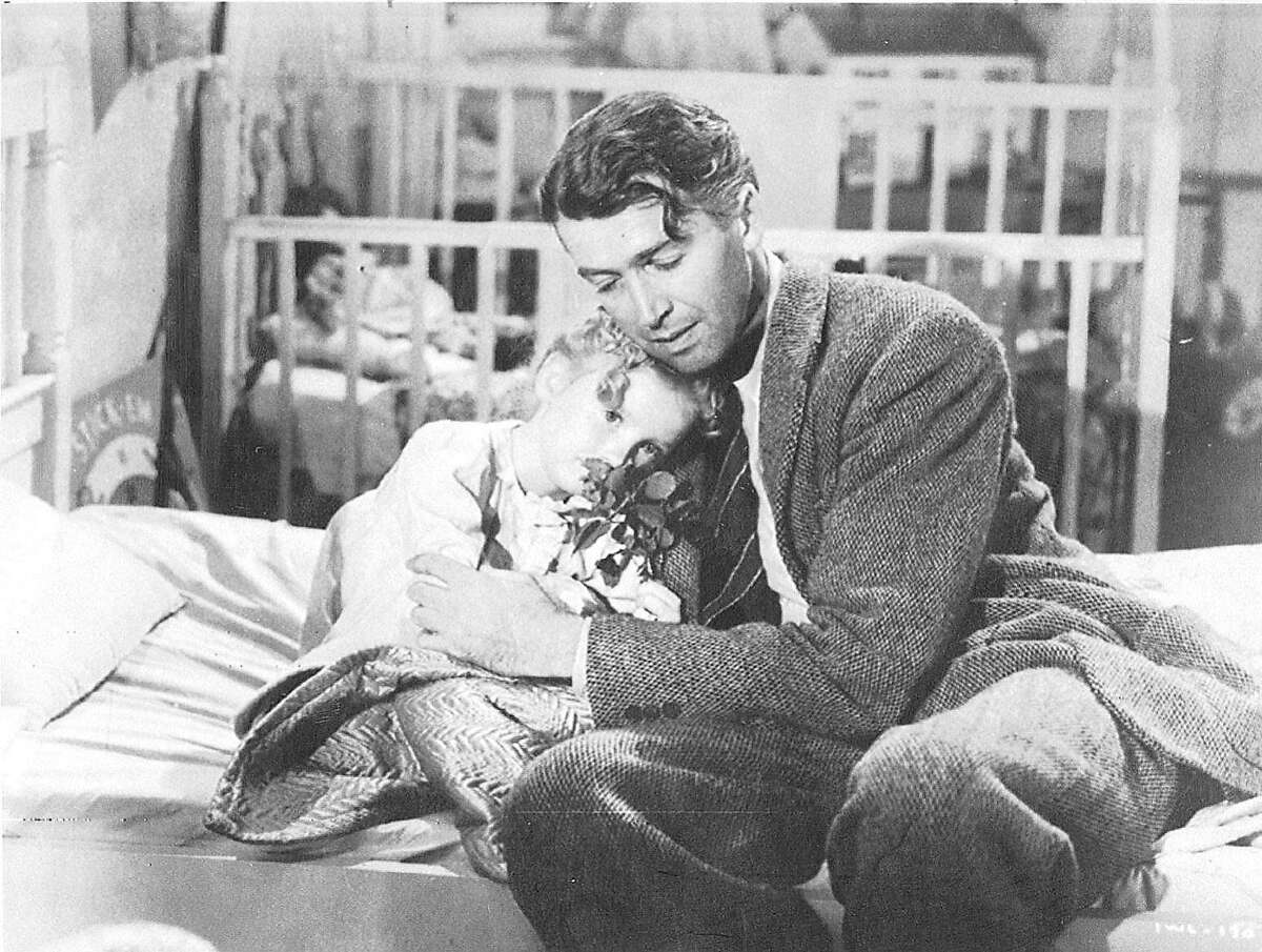 Karolyn Grimes (as Zuzu) and Jimmy Stewart (as George Bailey) in a scene from the 1946 film "It's a Wonderful Life"