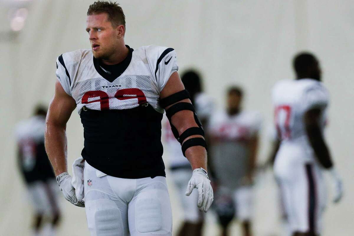 After back surgery earlier this summer to repair a herniated disc, Houston Texans defensive end J.J. Watt (99), left, returns to practice at the Houston Methodist Training Center Monday, September 5, 2016 in Houston.