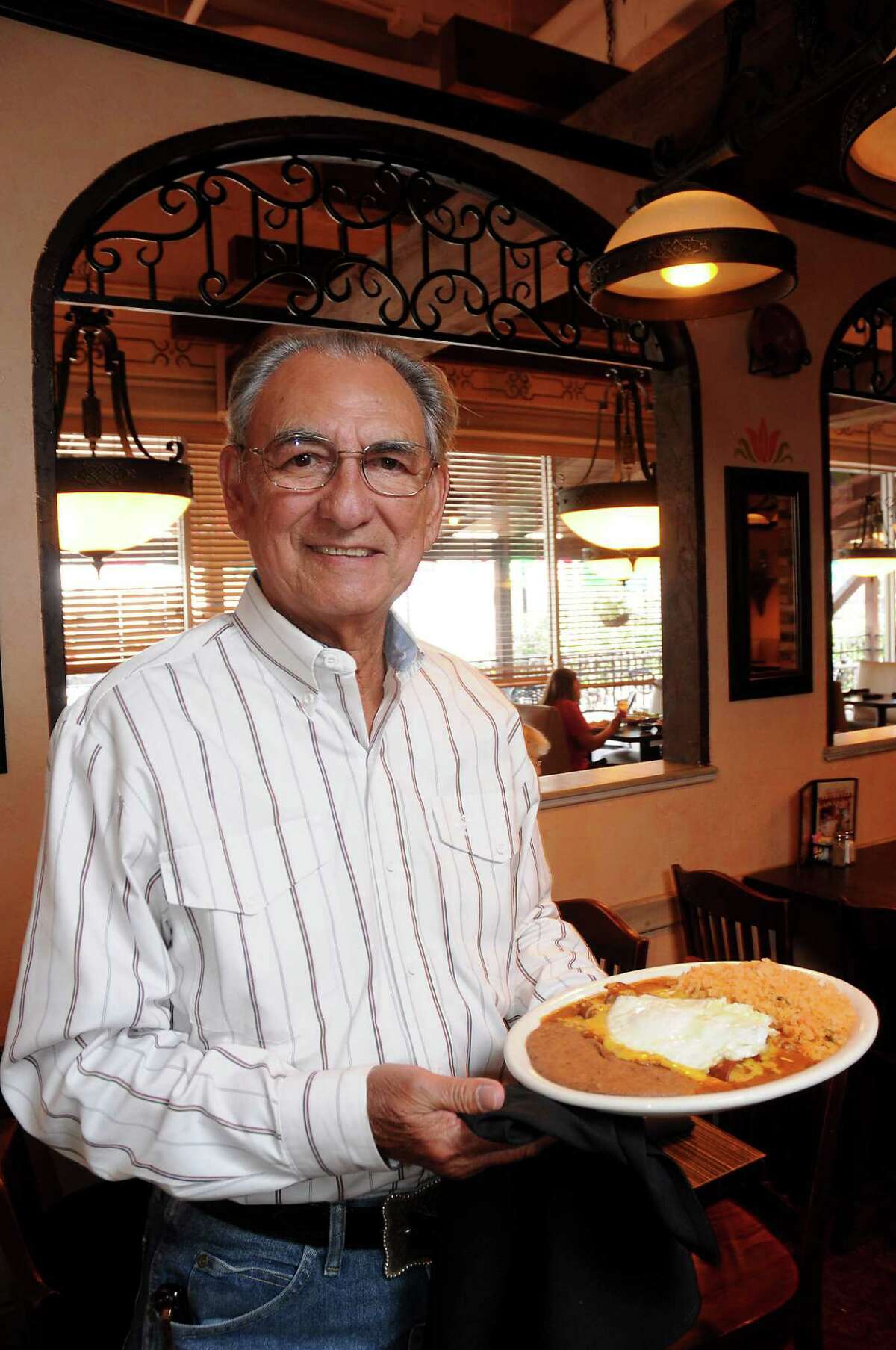 Raul Molina Jr. with a plate of cheese enchiladas and a fried egg at Molina's Cantina on Bellaire Tuesday Aug. 30, 2016. (Dave Rossman Photo)
