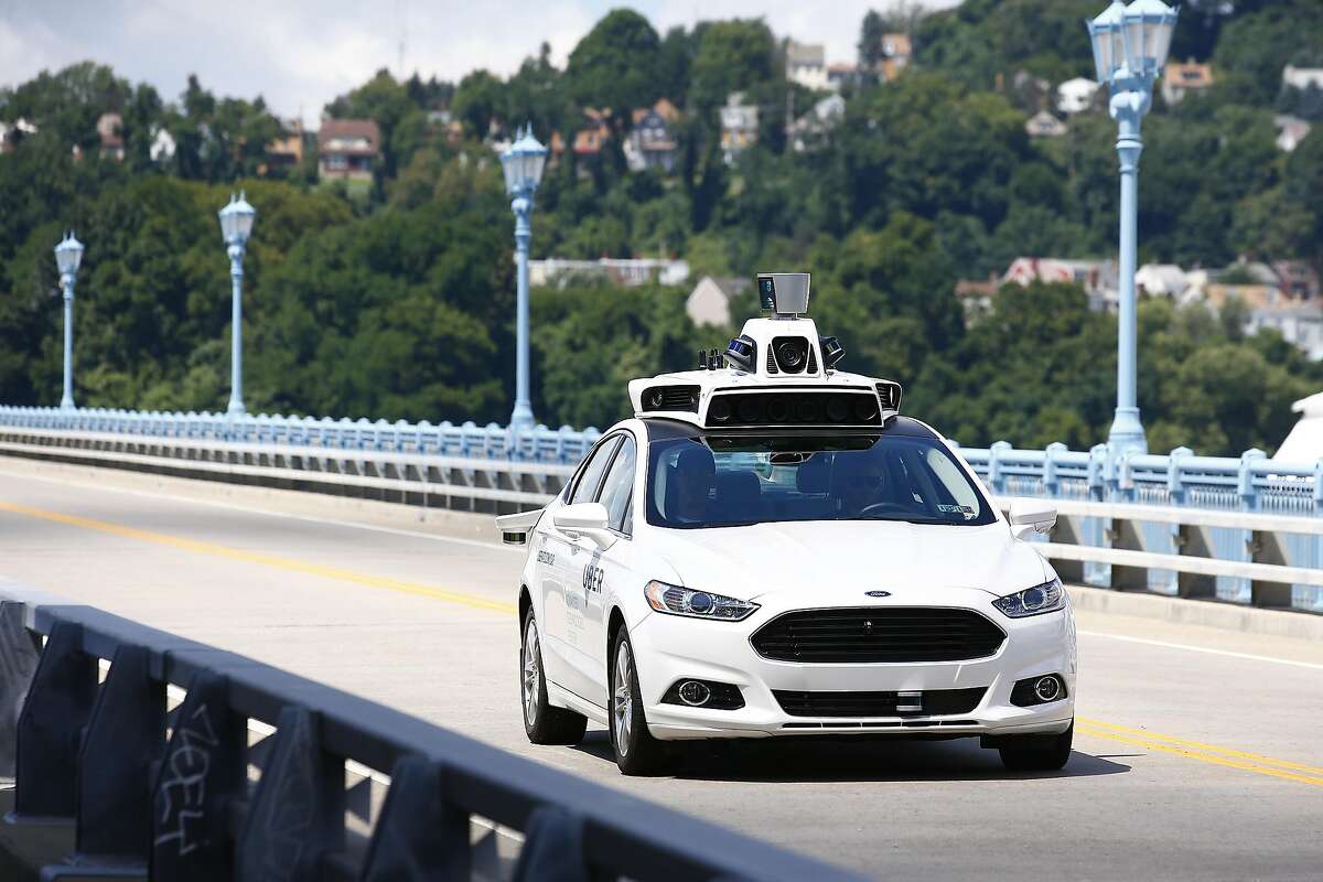 Uber employees test the self-driving Ford Fusion hybrid cars in Pittsburgh, Pa on Thursday, Aug. 18, 2016. (AP Photo/Jared Wickerham)