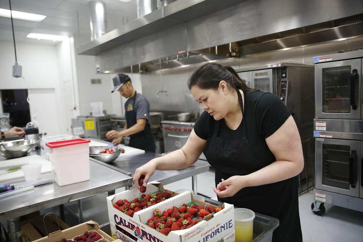 Gillian Reynolds, Jamnation founder, chooses out some strawberries so they can be prepped to be made into jam at a South Basin Partners commercial kitchen on Monday, September 5, 2016 in San Francisco, California.