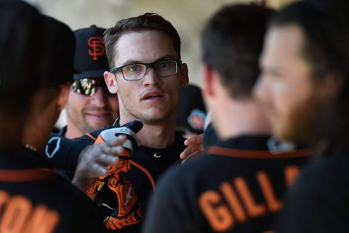 SCOTTSDALE, AZ - MARCH 20: Kelby Tomlinson #37 of the San Francisco Giants returns to the dugout after scoring in the second inning against the Colorado Rockies on March 20, 2016 in Scottsdale, Arizona. (Photo by Lisa Blumenfeld/Getty Images)
