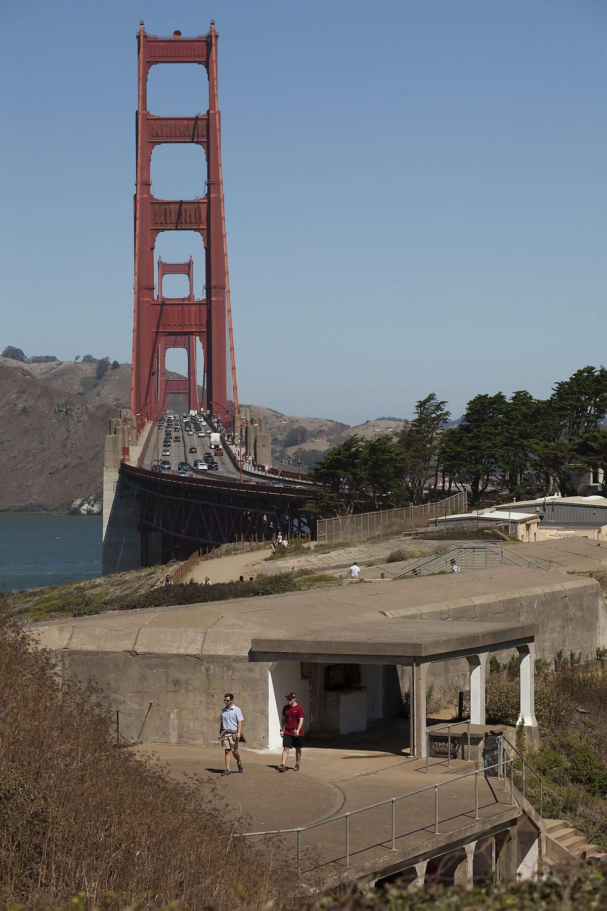Tourist stroll over the top of Battery Marcus Miller, a partially underground, reinforced-concrete bunker, being used as a gallery space for the Home Land Security Exhibition in the Historic Military-Defense Structures in the Presidio over looking the Golden Gate bridge, in San Francisco, California, USA 30 Aug 2016. (Peter DaSilva/Special to The Chronicle)