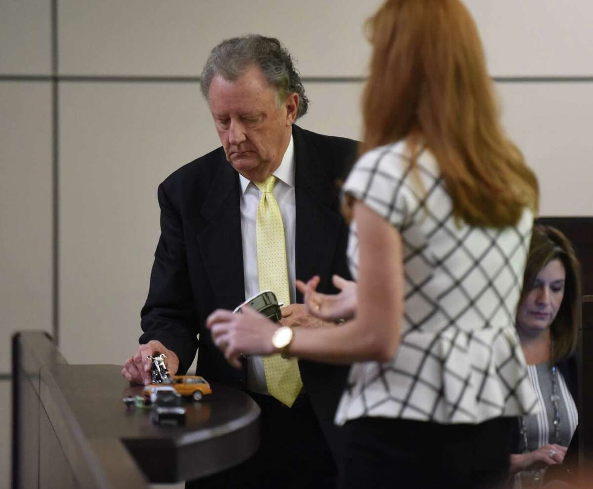 Charles R. Ruble, accident reconstruction specialist, demonstrates how he believes the highway wreck that killed Bill Hall Jr. happened as defense attorney Leigh Cutter looks on during the murder trial of Frances Hall on Tuesday, Sept. 6, 2016, in 186th District Court. Hall is accused in the 2013 death of her husband, who fell from his motorcycle while he, his wife and his lover were involved in a highway chase.