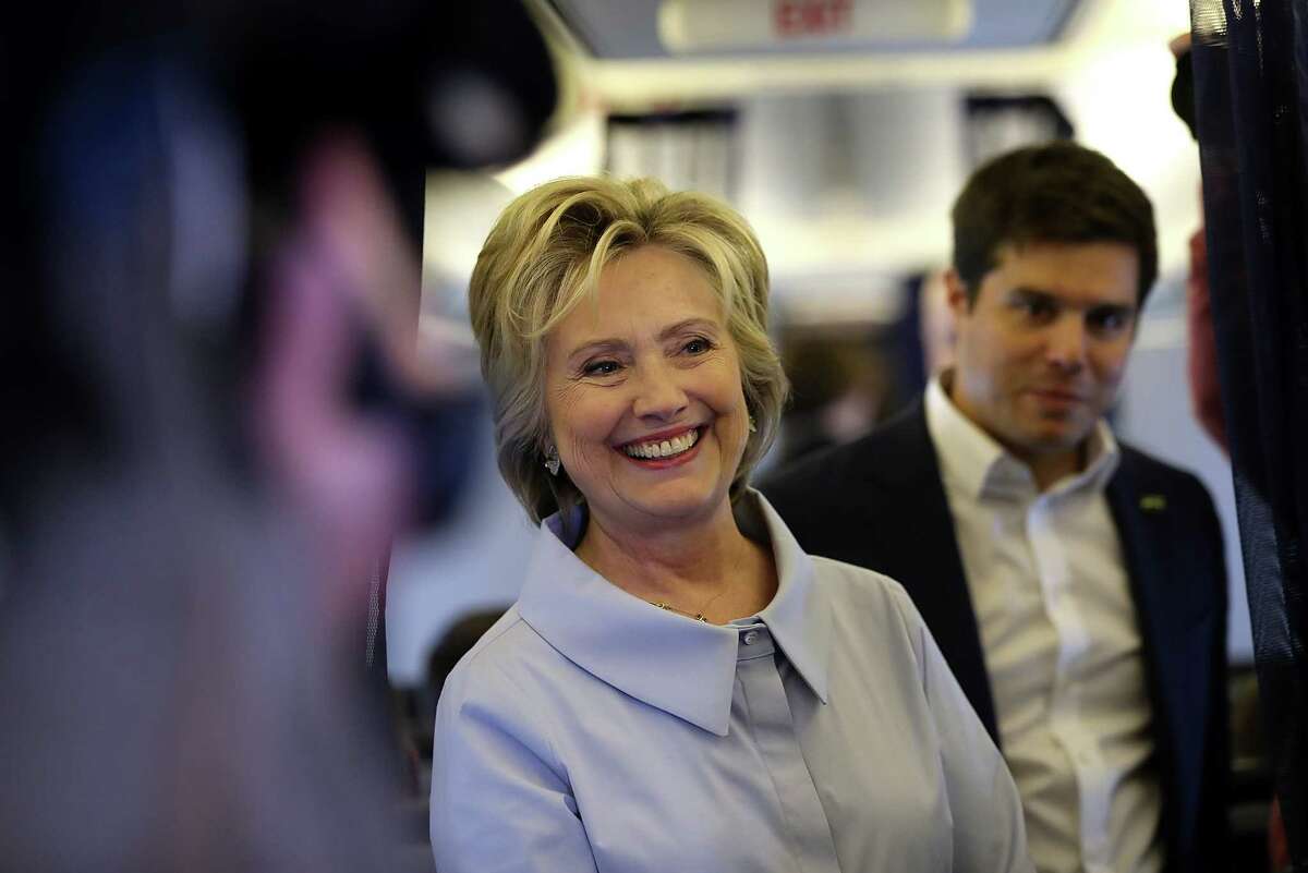 WHITE PLAINS, NY - SEPTEMBER 05: Democratic presidential nominee former Secretary of State Hillary Clinton chats with reporters aboard her new campaign plane at Westchester County Airport on September 5, 2016 in White Plains, New York. Clinton is kicking off a Labor Day campaign swing to Ohio and Iowa on a new campaign plane large enough to accomodate her traveling press corp. (Photo by Justin Sullivan/Getty Images)