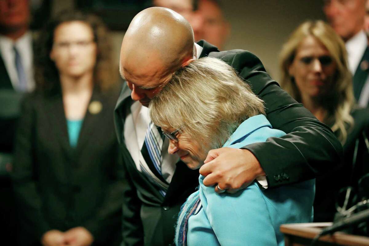 Patty Wetterling is consoled by son Trevor during a news conference after a hear for Danny Heinrich, Tuesday, Sept. 6, 2016 in Minneapolis. Heinrich confessed Tuesday to abducting and killing 11-year-old Jacob Wetterling nearly 27 years ago, recounting a crime that long haunted the state with details that included Jacob asking right after he was taken: "What did I do wrong?" (Jerry Holt/Star Tribune via AP)