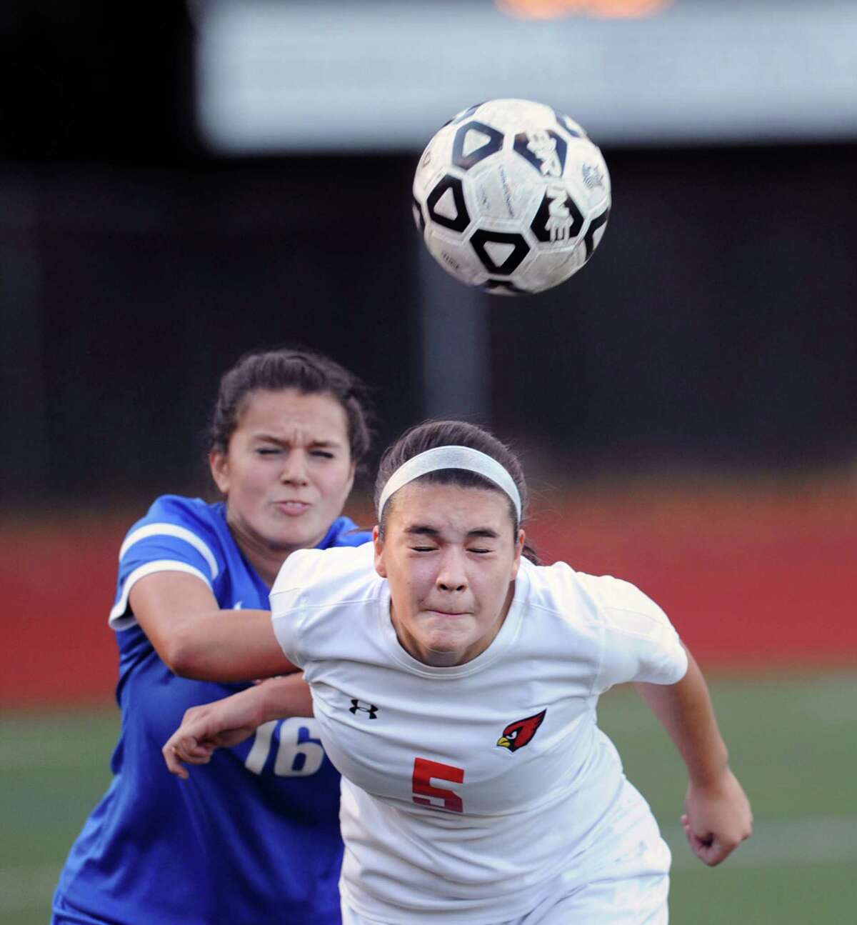 Kimberly Kockenmeister (5) of Greenwich heads the ball as Danbury's Taylor Izzo defends during action last season.