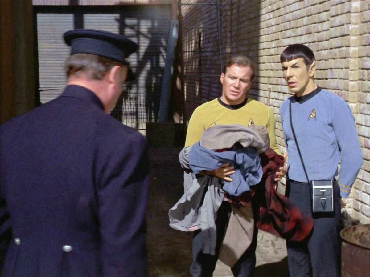 Star Trek, The Original Series, episode 'The City on the Edge of Forever' first broadcast on April 6, 1967. Seen here, from left to right, Hal Baylor (back to camera, as Policeman), William Shatner (as Captain James T. Kirk) and Leonard Nimoy (as Mr. Spock) in year 1930. Image is a screen grab.