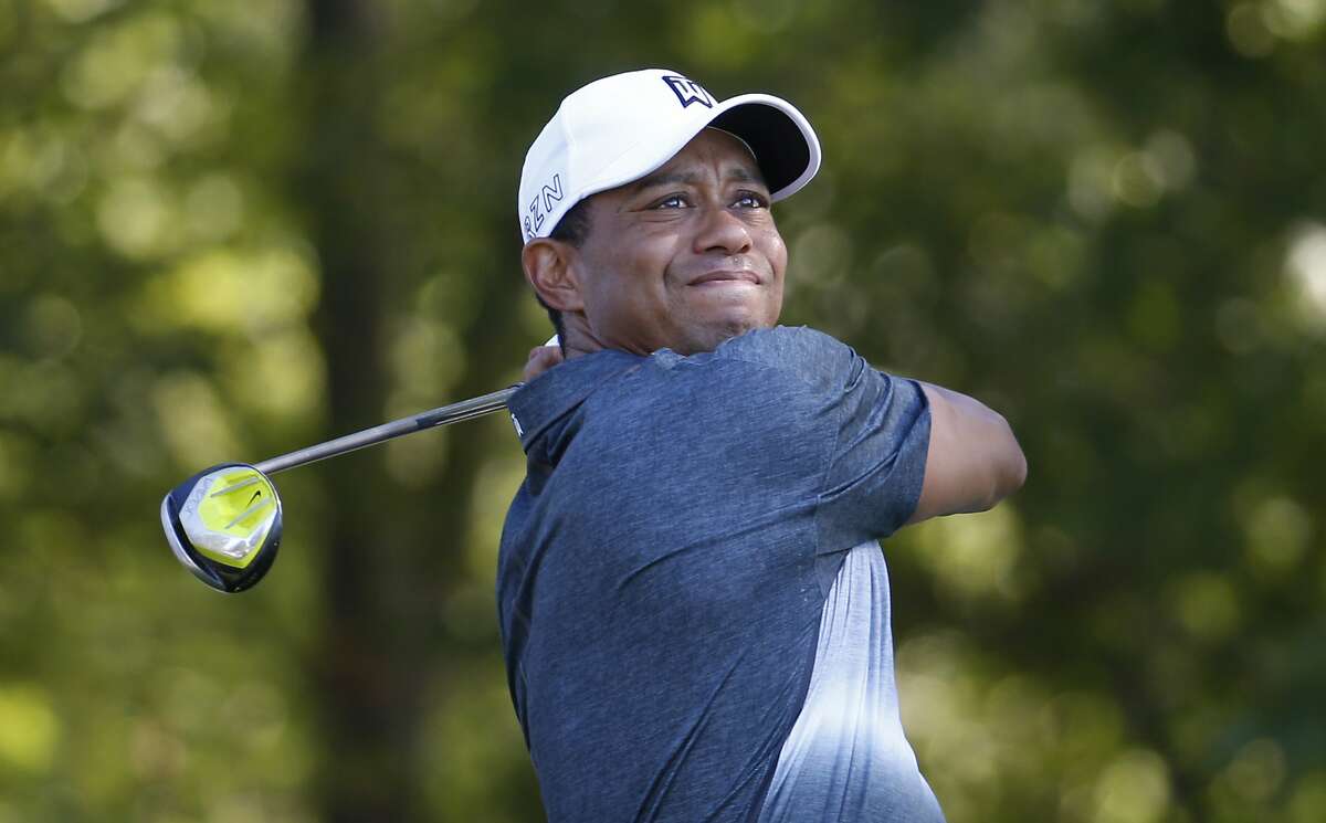 FILE - In this July 31, 2015, file photo, Tiger Woods watches his tee shot on the 13th hole during the second round of the Quicken Loans National golf tournament, in Gainesville, Va. Tiger Woods says he hopes to play next month in the PGA's Safeway Open in Napa, California, his first competitive golf since August 2015. (AP Photo/Steve Helber, File)