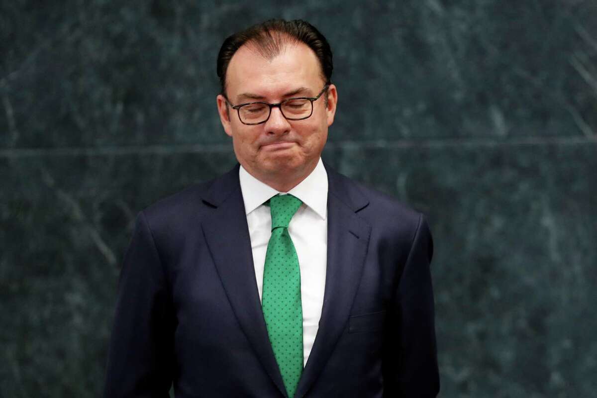 Mexico's Finance Secretary Luis Videgaray looks down as President Enrique Pena Nieto announces Videgaray's resignation at Los Pinos presidential residence in Mexico City, Wednesday, Sept. 7, 2016. One of Pena Nieto's closest advisers and confidants, Videgaray handed in his resignation, in a move observers said was linked to the unpopular decision to invite Republican presidential nominee Donald Trump to visit Mexico. (AP Photo/Dario Lopez-Mills)