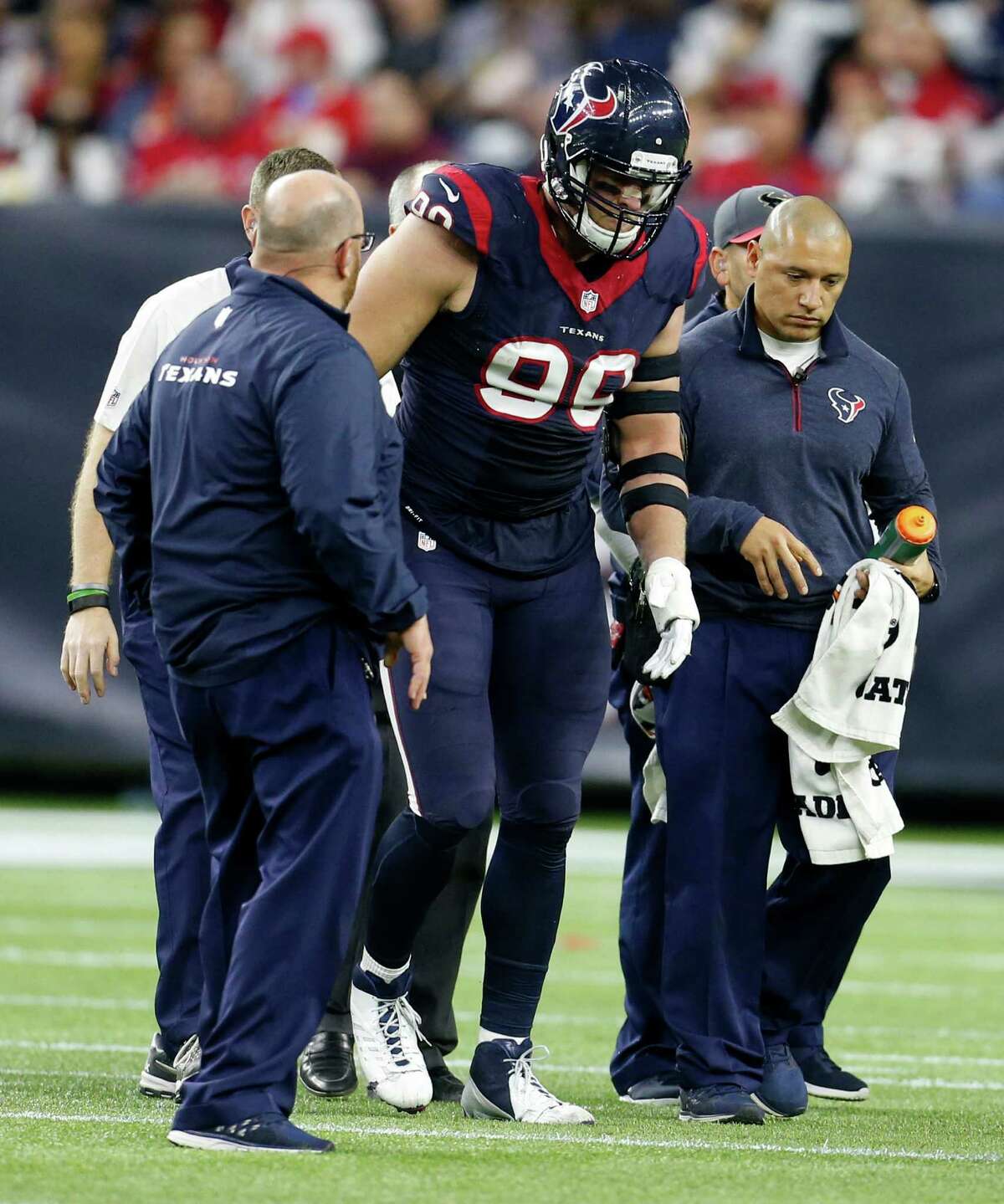 Houston Texans defensive end J.J. Watt (99) comes off the field after being injured during the third quarter of an AFC Wildcard playoff game at NRG Stadium on Saturday, Jan. 9, 2016, in Houston. ( Karen Warren / Houston Chronicle )