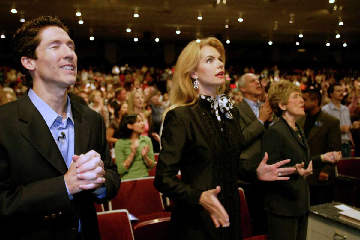 9/25/04--Lakewood Church's Joel Osteen, from left, his wife Victoria Osteen and mother Dodie Osteen sing along with their choir to open up their Saturday evening service, Sept. 25, 2004, in Houston. Osteen leads America's largest church with plans to worship in the Compaq Center in 2005. (Kevin Fujii/Chronicle)