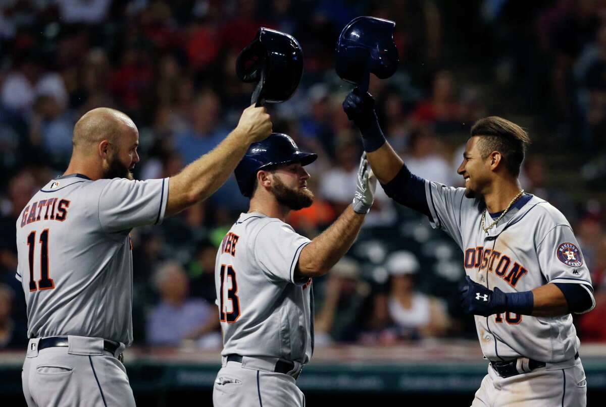 It's hats off to Yulieski Gurriel, right, who slugged his first home run in the majors Wednesday night. Astros teammates Evan Gattis, left, and Tyler White help celebrate Gurriel's two-run shot in the eighth inning.