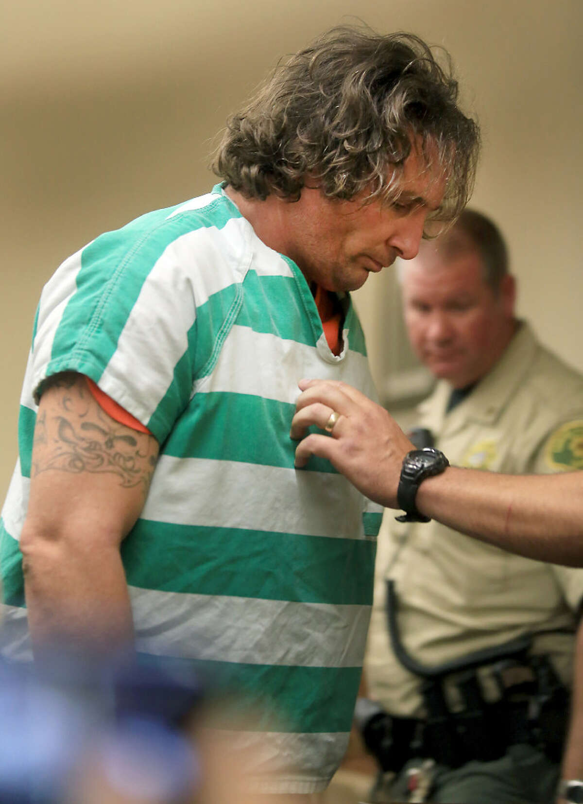 This Aug. 17, 2016 file photo shows serial arson suspect Damin Pashilk being taken from Lake County Superior Court in Lakeport, Calif.