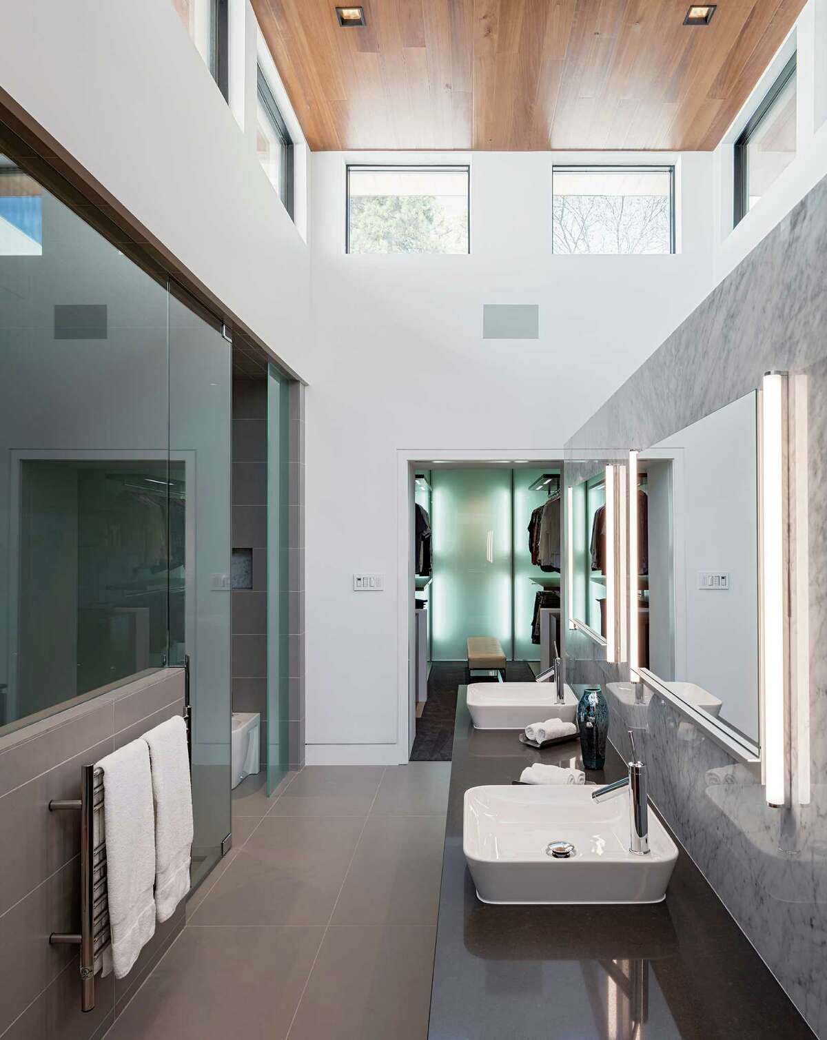 Clerestory windows bring natural light into the master bathroom designed by Messick.