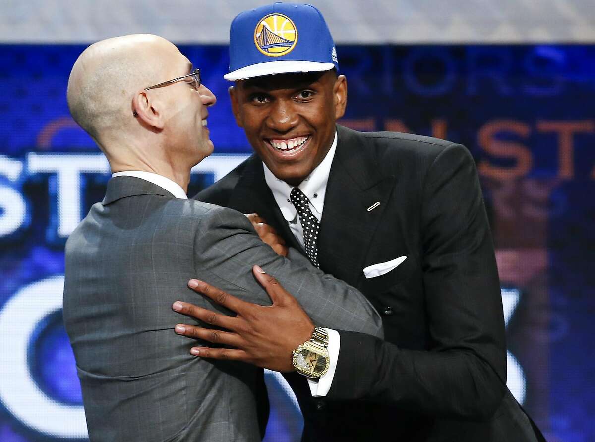 Kevon Looney, right, greets NBA Commissioner Adam Silver after being selected 30th overall by the Golden State Warriors during the NBA basketball draft, Thursday, June 25, 2015, in New York. (AP Photo/Kathy Willens)