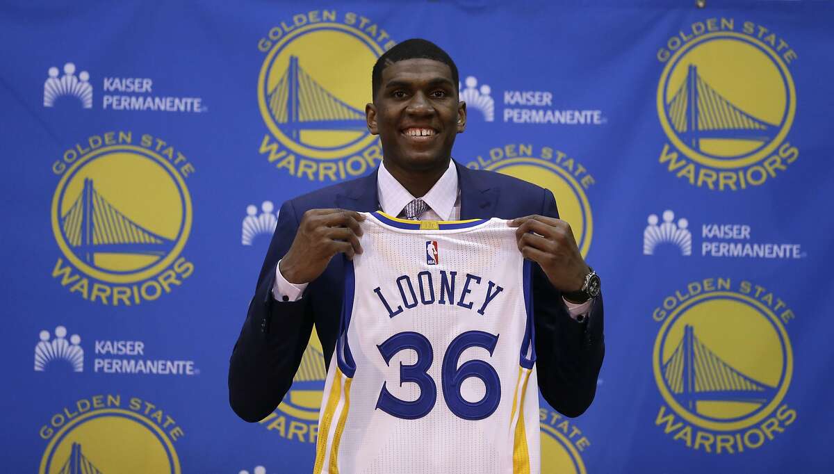 Golden State Warriors' Kevon Looney holds his new jersey during a media conference Friday, June 26, 2015, in Oakland, Calif. With the 30th overall pick in the first round of Thursday's draft, the Golden State Warriors selected UCLA forward Kevon Looney. (AP Photo/Ben Margot)