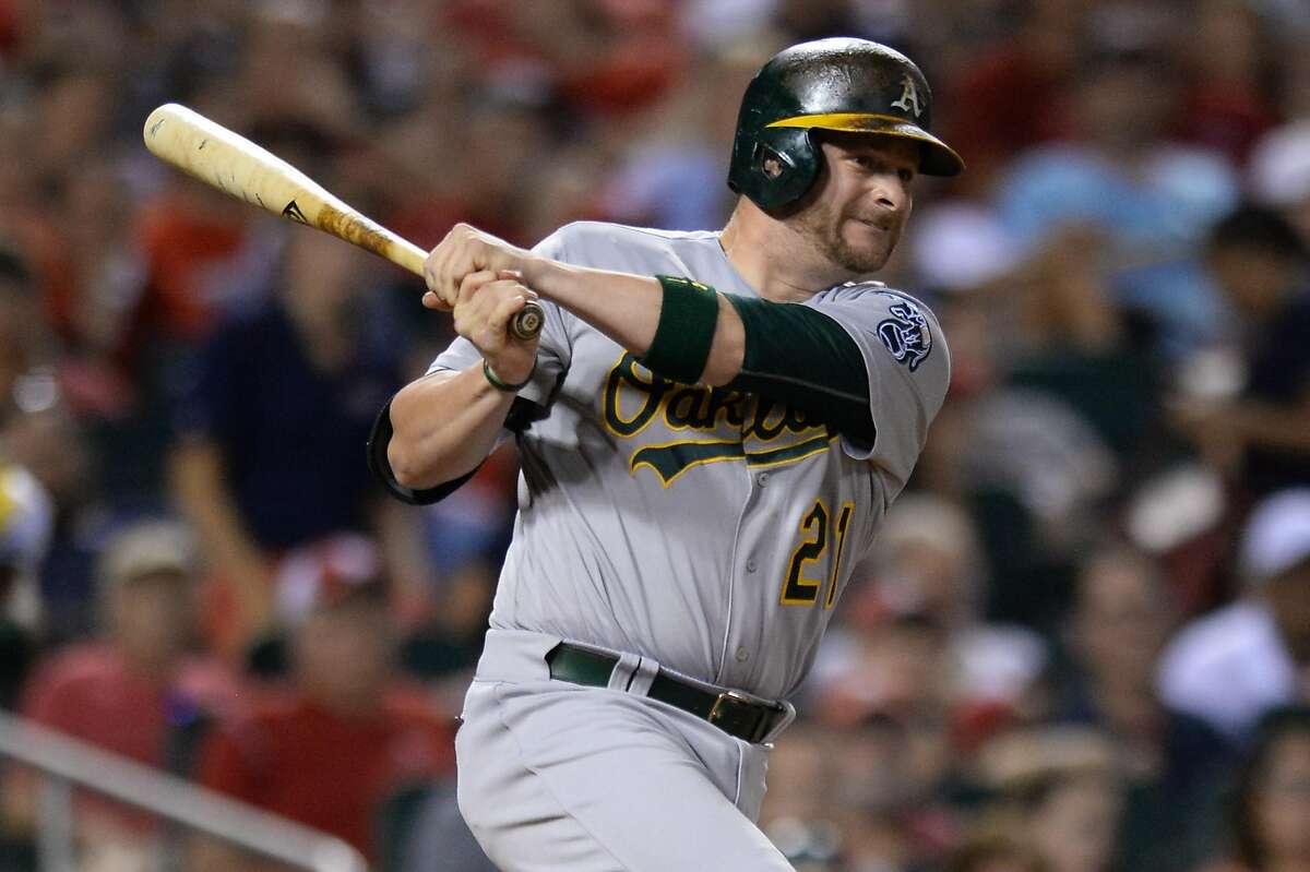 Oakland Athletics' Stephen Vogt (21) bats against the St. Louis Cardinals during a baseball game on Saturday, Aug. 27, 2016, in St. Louis. (AP Photo/Michael Thomas)