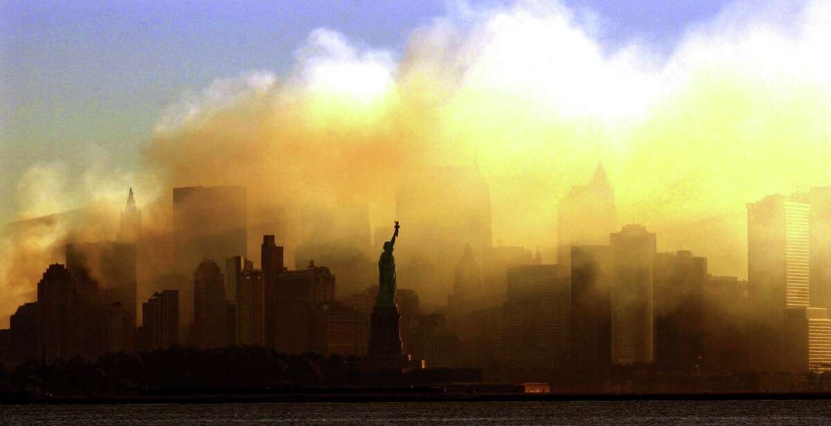 The Statue of Liberty stands before the smoke rising from Ground Zero after the September 11, 2001 terror attacks.