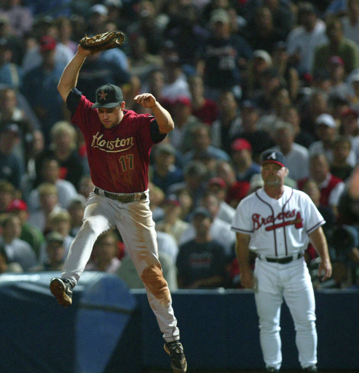 Lance Berkman leaps up to catch the ground ball hit by Andruw Jones during the 5th inning of Game Two of the National League Division Series, between the Houston Astros and the Atlanta Braves, at Turner Field in Atlanta, Georgia, Thursday, October 6, 2005(Karen Warren/Houston Chronicle)