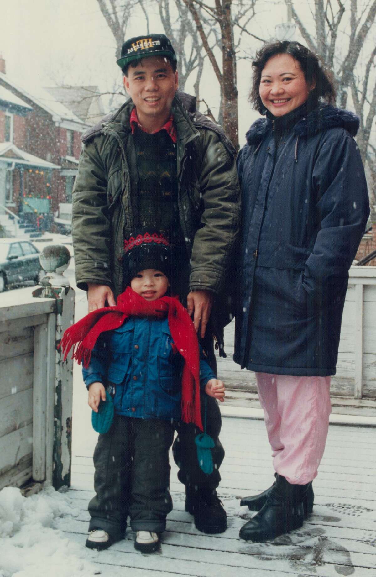 FILE-- Kim Phuc; husband Huy Toan; and son Huy Hoang outside their Toronto home. She was the little girl, burned by napalm, seen running and screaming in pain in a Vietnam war picture that shocked the world.