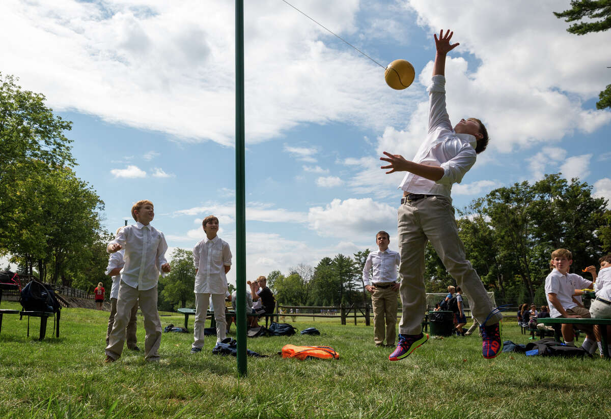 Sixth grader Carson Miles leaps for the tether ball during the Stanwich School's annual Welcome Back Picnic and Triskelion Cup Kickoff at the Stanwich School in Greenwich, Conn. on Friday, September 9, 2016.